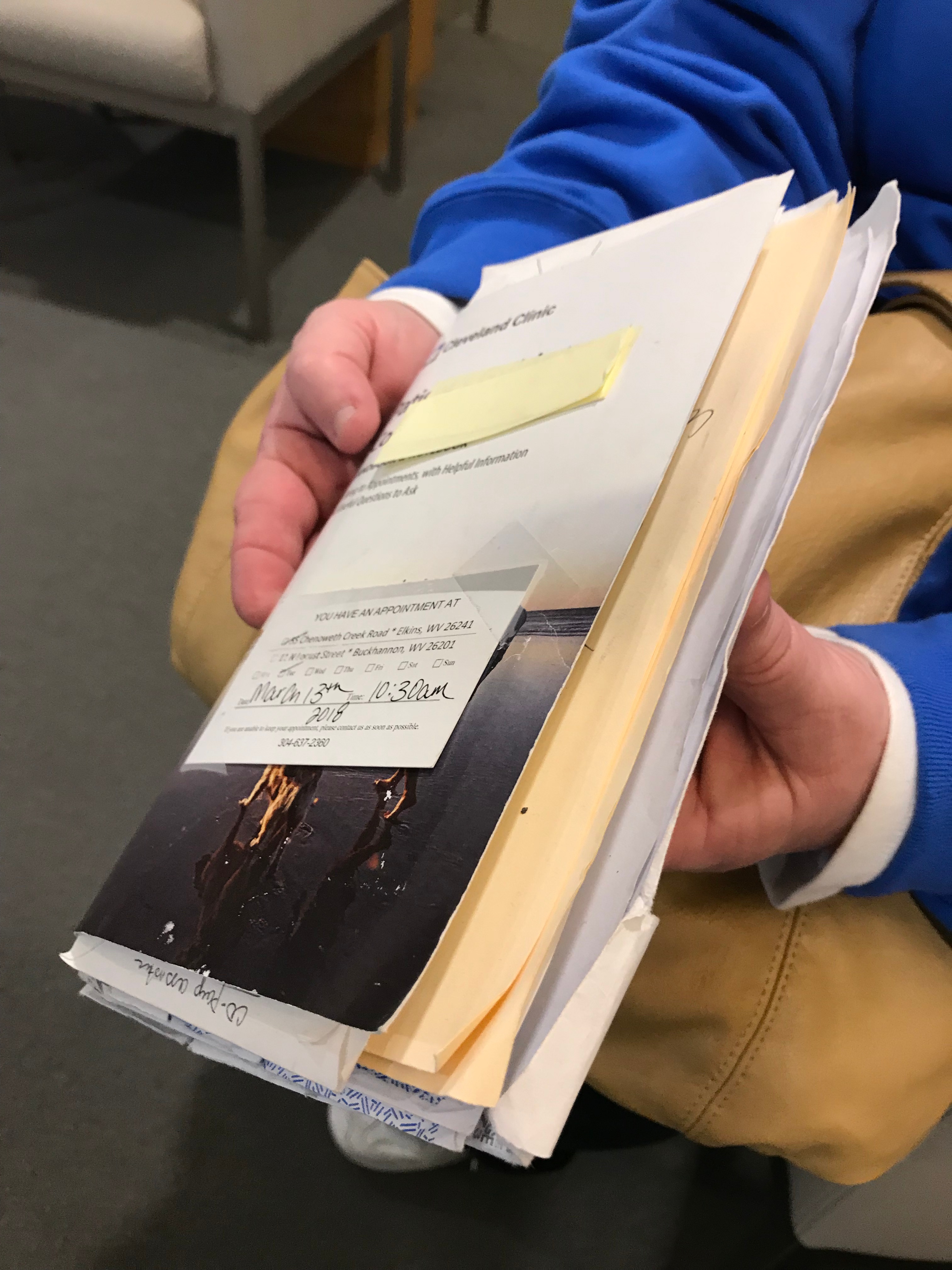 Patient showing their cancer handbook