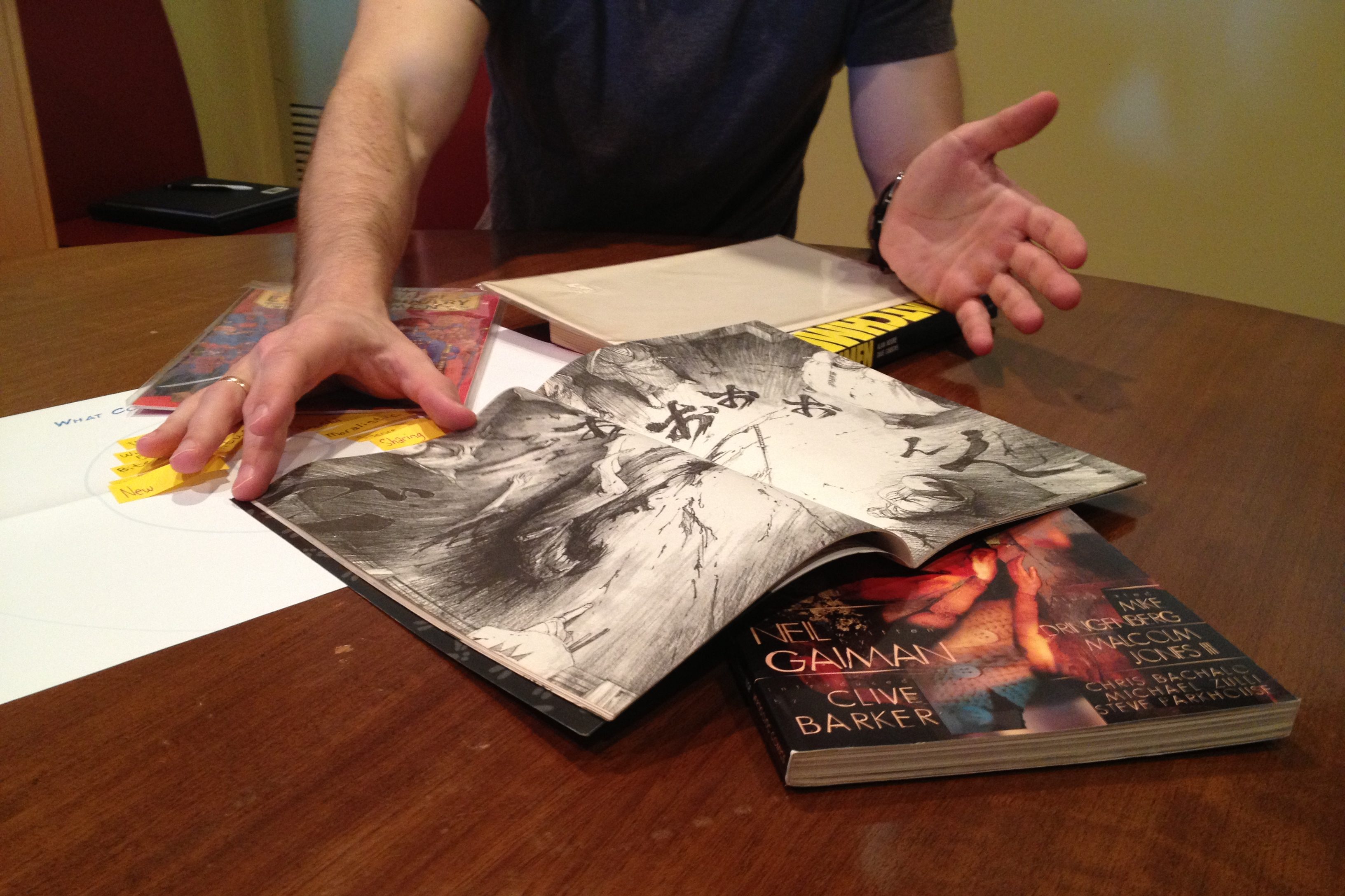 Person showing their comic collection