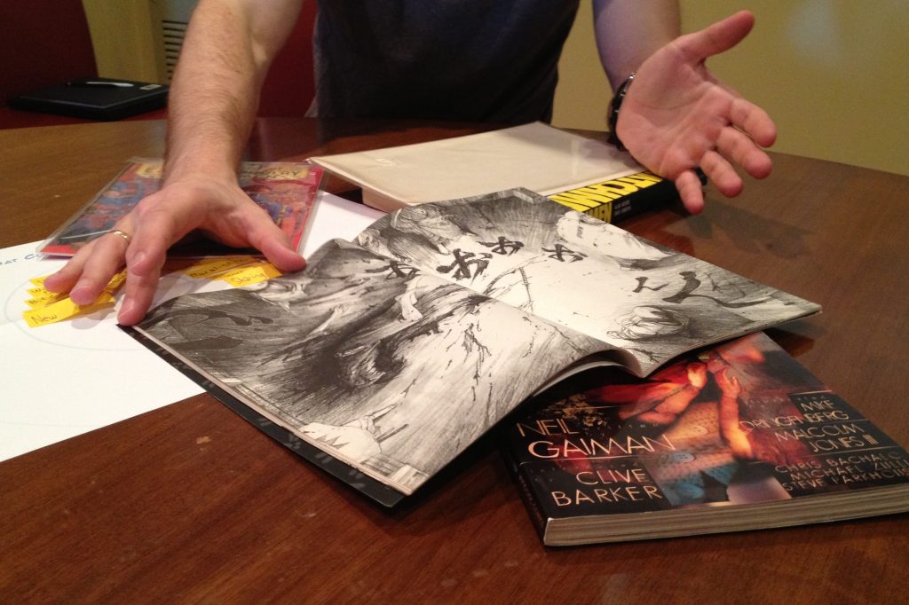 Person showing their comic collection